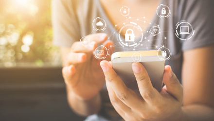 Using smartphone with icon graphic cyber security network of connected devices and personal data iStock-1090870004.jpg